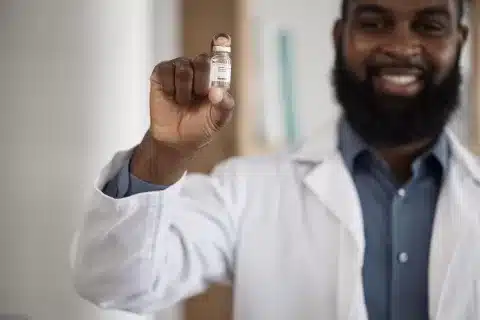 Doctor holding a bottle of Testosterone for those battling with Low Testosterone Levels